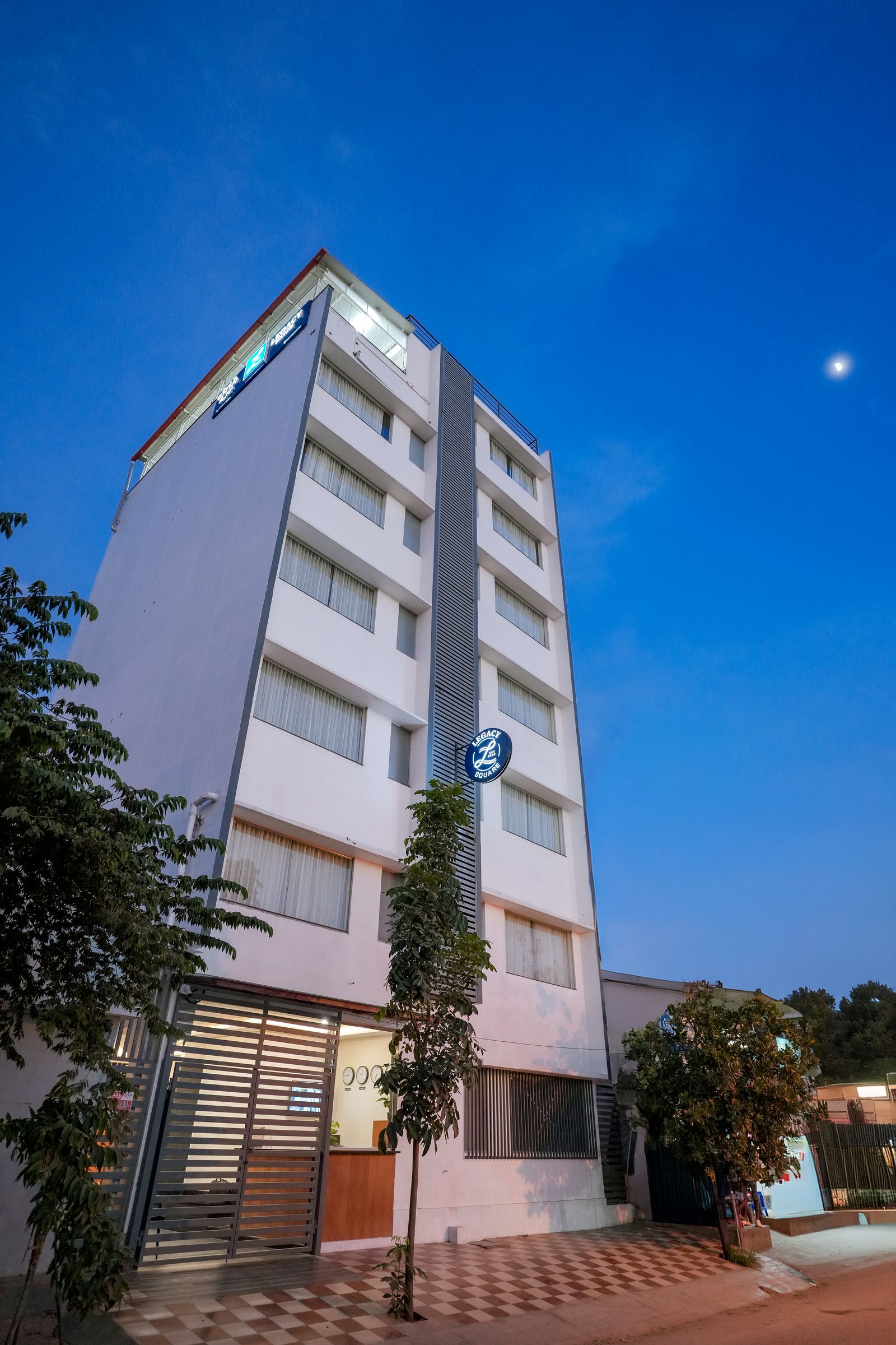 Legacy Square Hotel building exterior at dusk, Rajarajeshwari Nagar, Bengaluru