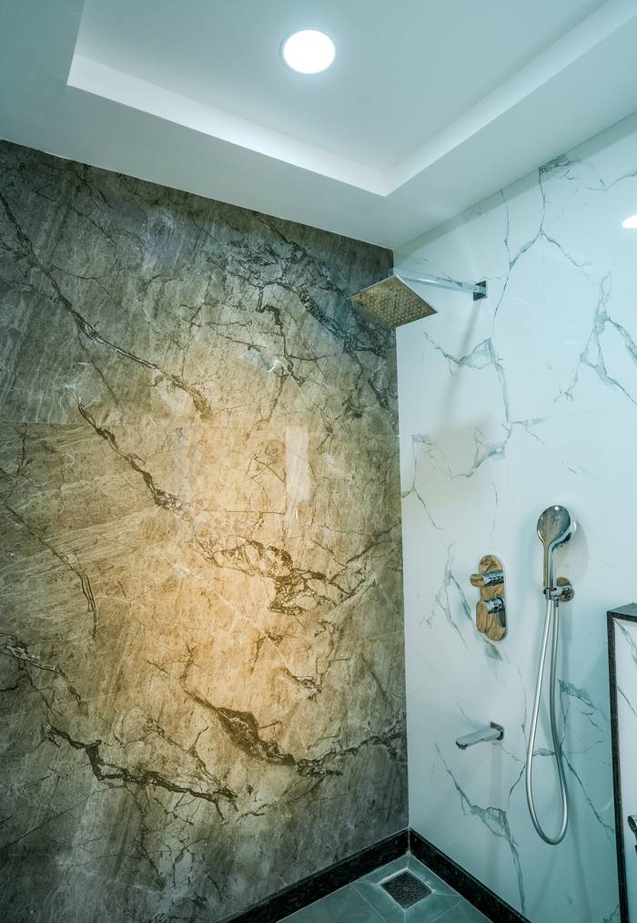 Guest bathroom shower detail at Legacy Square Hotel